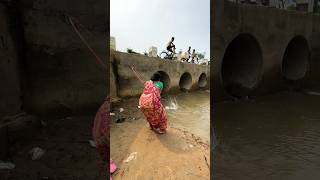 A woman catches fish from a large dam with a hook  amazing fishing in the canal  fishing shorts [upl. by Farah]