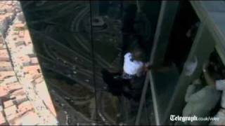 French Spiderman Alain Robert slips off side off building in rare fall [upl. by Yzzo858]