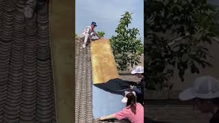 The process of paving self adhesive waterproof fabric on house roof [upl. by Close]